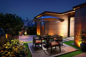 Modern rooftop patio with city view at night.