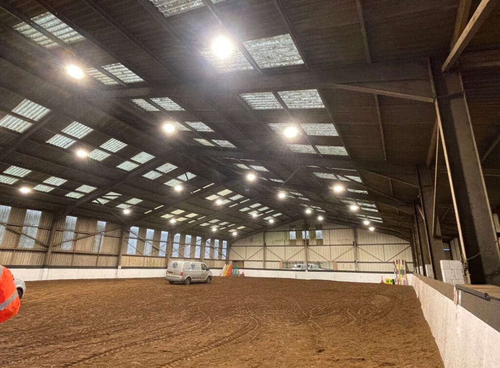 Indoor riding arena with damp sand floor