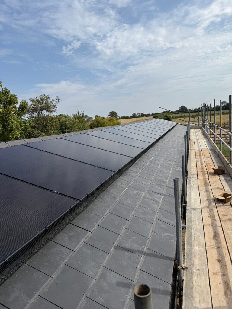 Rooftop solar panels under a clear blue sky.