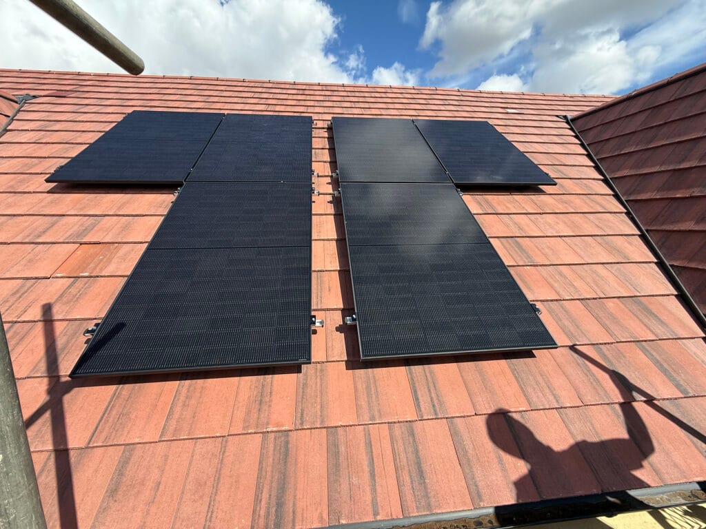 Solar panels installed on red tiled roof