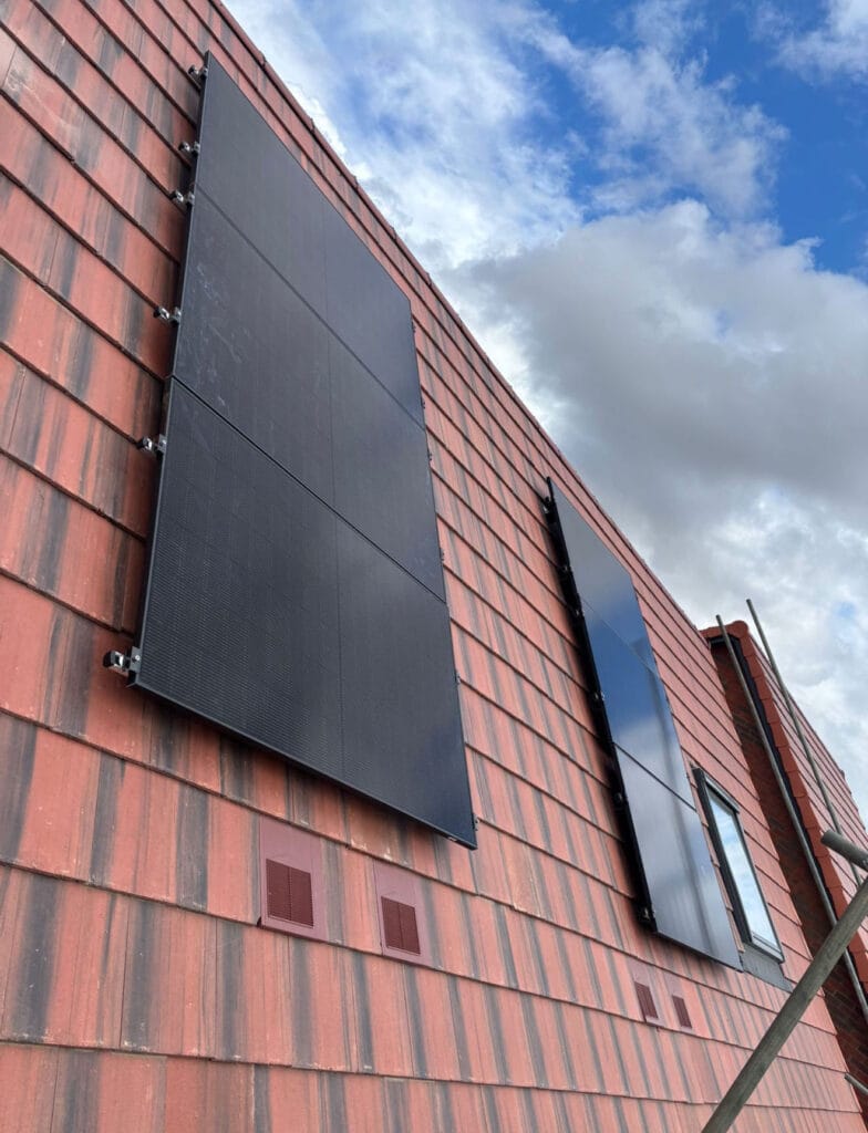 Solar panels installed on red roof tiles.