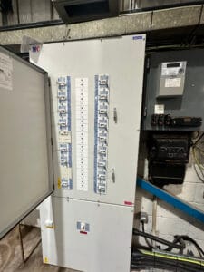 Electrical fuse box in a utility room.