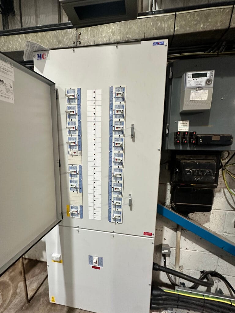 Electrical fuse box in a utility room.